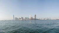 a view of the city skyline from across the water looking out over a city with tall buildings