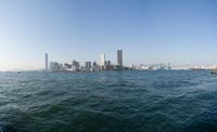 a view of the city skyline from across the water looking out over a city with tall buildings
