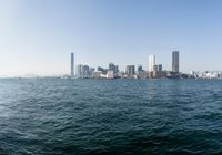 a view of the city skyline from across the water looking out over a city with tall buildings