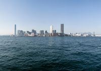 a view of the city skyline from across the water looking out over a city with tall buildings
