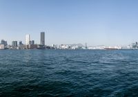 a view of the city skyline from across the water looking out over a city with tall buildings