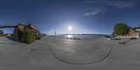 a fisheye lens is shown with some benches around it's edges and sun in the background