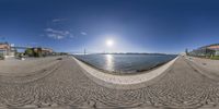 some fisheye looking photos of an outdoor setting and a body of water with buildings, a bridge, and a large body of water