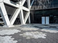 an open walkway outside a very modern building made of bricks and steel strips in a city