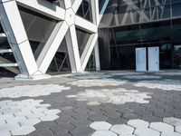 an open walkway outside a very modern building made of bricks and steel strips in a city