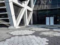 an open walkway outside a very modern building made of bricks and steel strips in a city