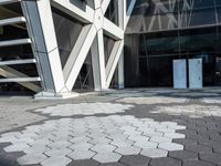 an open walkway outside a very modern building made of bricks and steel strips in a city