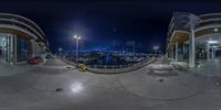 an outside view of some docks and boats at night with the sky lit up from behind