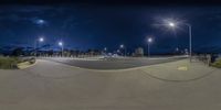 a wide angle view of the street at night with all lights turned on in this time lapsure photo