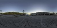 the fisheye view of a body of water from inside a pier next to a building