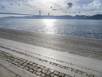 a city park area along the water next to a bridge and water's edge