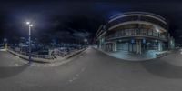 a fish eye view of a city with a ramp near by at night time from above a skateboard ramp