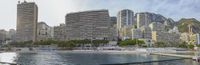 the beach in the middle of a large city has several tall buildings and skyscrapers