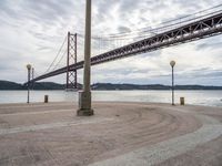 there is a large red bridge that stretches into the water with no one in it