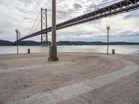 there is a large red bridge that stretches into the water with no one in it