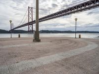 there is a large red bridge that stretches into the water with no one in it