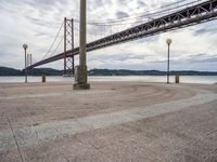 there is a large red bridge that stretches into the water with no one in it