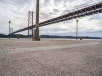 there is a large red bridge that stretches into the water with no one in it