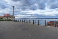 the view of the ocean and buildings on the shore of the lake from the boardwalk