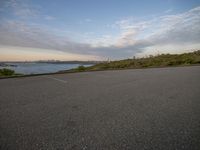 an empty parking lot with a city in the background during sunset or sunset time,