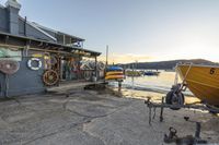 the dock in front of a small fishing hut with many boats out on water near it