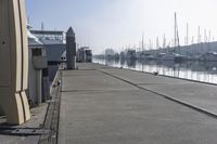 there are many boats in the water by the pier on this dock, as well as several parked boats