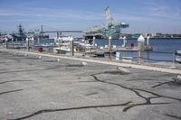 a harbor with several boats docked along side of it with a pier in the background