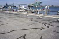 a harbor with several boats docked along side of it with a pier in the background