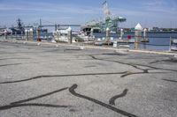 a harbor with several boats docked along side of it with a pier in the background