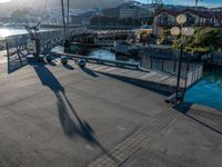 a bridge with several seagulls sitting on the walkway next to it and a body of water and mountains in the background