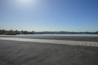 this is the beach outside of an empty building, in front of a body of water