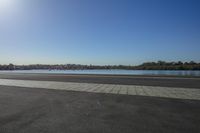 this is the beach outside of an empty building, in front of a body of water