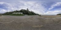 the view of a beach area with a house on it's side from a point of view