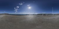 a fisheye lens panoramic view of a boat and pier and blue sky