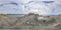 the sky is filled with clouds and rocks that resemble large hollows and other features of stone