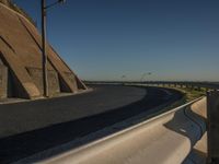 the side of a mountain next to the road and a freeway with two lanes on it