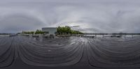 a picture of a large area with water and trees on top of it and a large water tank behind