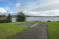 a parking spot is on the water front beach in a residential area that overlooks a bay and trees