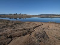 view of a lake and land with a dirt shore line in the middle of it