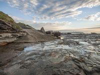 this photo shows the coastline at low tide time, as the water comes up onto the rocks