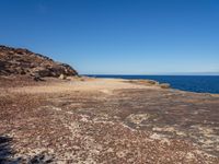 there is an image of an outcropping area near the water on the beach