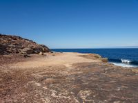 there is an image of an outcropping area near the water on the beach