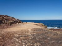 there is an image of an outcropping area near the water on the beach