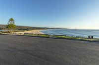 a view from the top of a hill, looking at the ocean and beach area