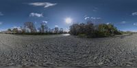 a panoramic view of some small land and water in the sky with the sun shining through