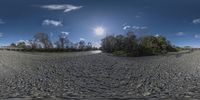 a panoramic view of some small land and water in the sky with the sun shining through