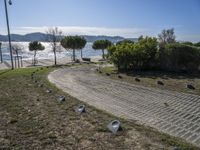 the walkway has been paved with brick pavers and birds all around it, and a beautiful ocean view