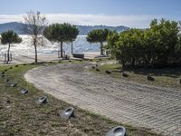 the walkway has been paved with brick pavers and birds all around it, and a beautiful ocean view