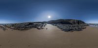 a panoramic view shows some very nice water and rocks and rocks on the beach