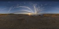 a very pretty fisheye lens with the sun behind it and people standing in the middle of it